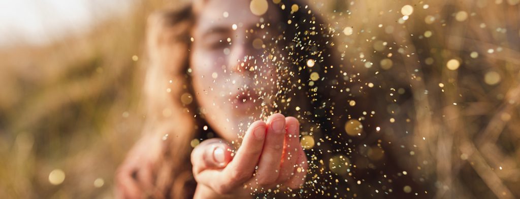 Woman blowing shimmer