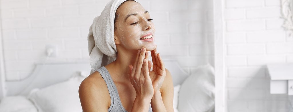 Woman appplying face mask for skincare