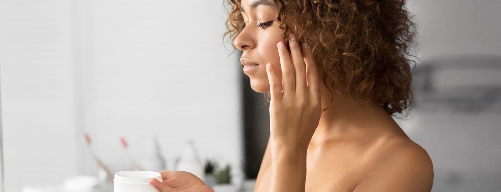 Woman applying liquid cream