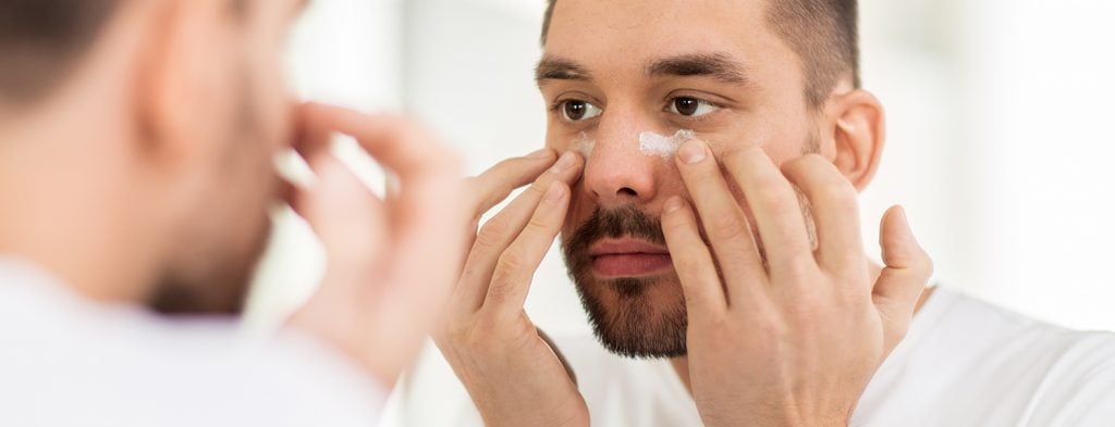 Man applying eye cream