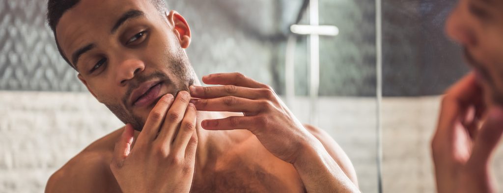 Man examining face